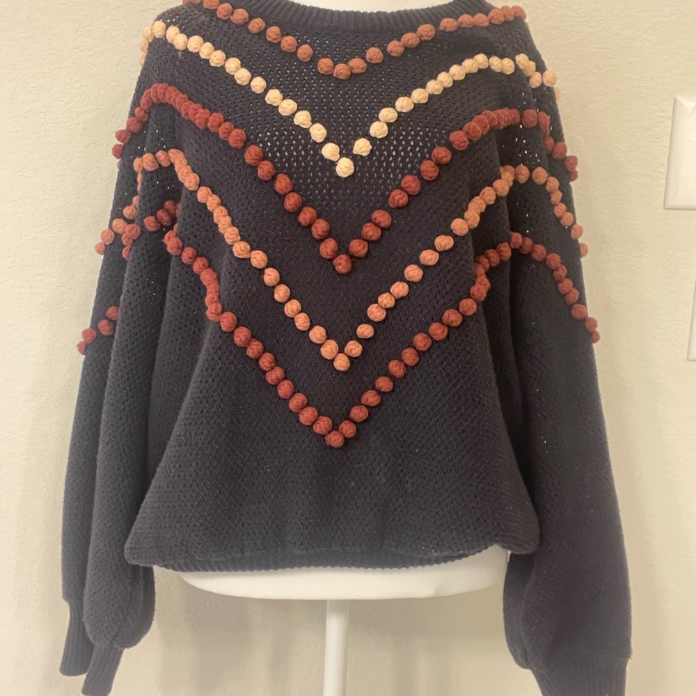 Chic Sweater with Colorful Pom-Poms